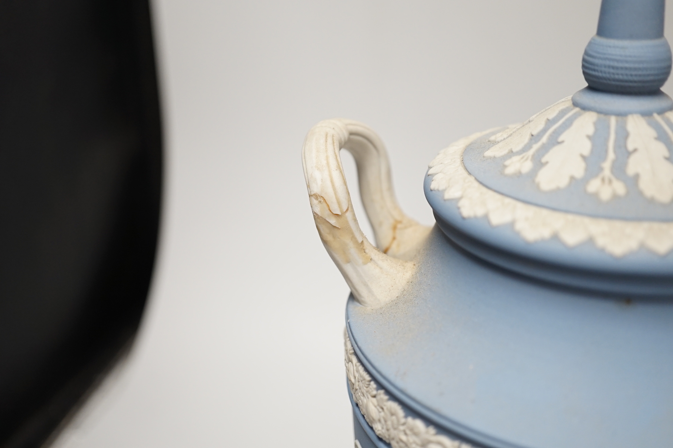 A Wedgwood blue jasper commemorative urn and cover and a similar smaller urn and cover, tallest 31cm